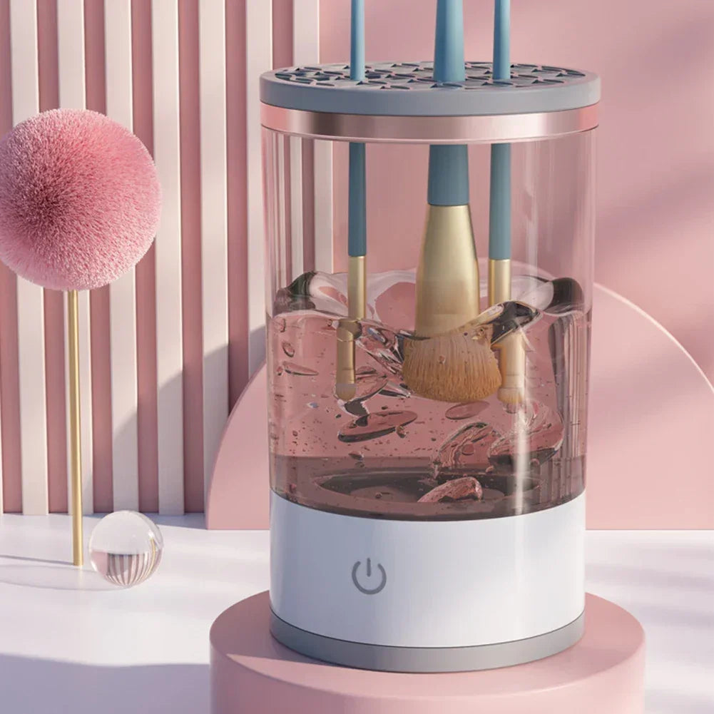 Electric makeup brush cleaner with spinning brushes in a clear container, pink modern background