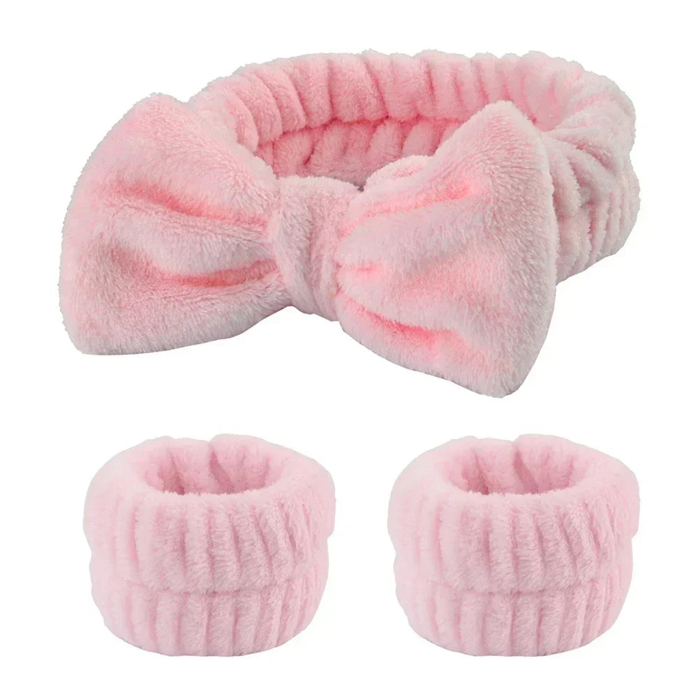 Soft pink plush headband with bow and matching wristbands for beauty routine