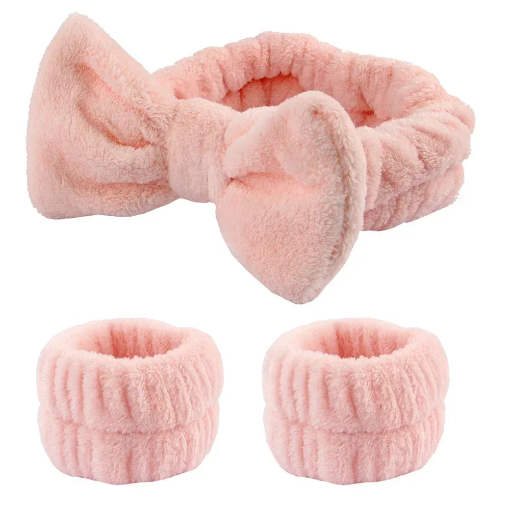 Set of soft pink plush headband with bow and matching wristbands for skincare routines