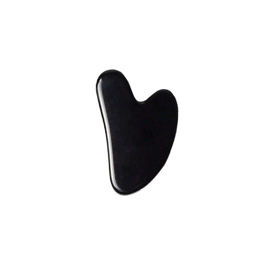 Black gua sha stone facial massage tool on white background
