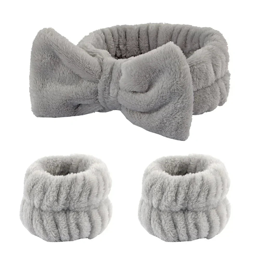 Plush grey headband with bow and matching wristbands, soft spa accessories set on white